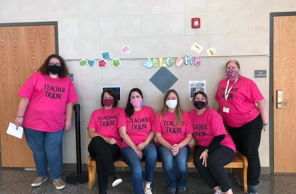 elementary teachers posing while wearing teacher tribe shirts