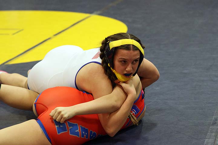 girl wrestling pushing other girl to her back