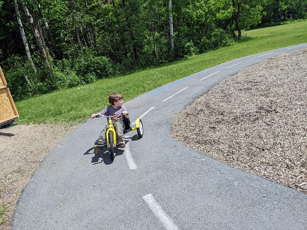elementary boy riding a trike