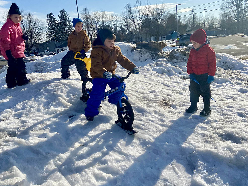 Student on Snow Bike on a Hill