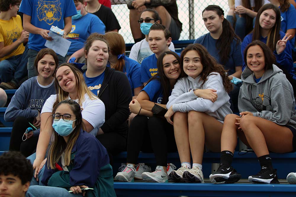 students from the class of 2022 posing for a picture on the football bleachers