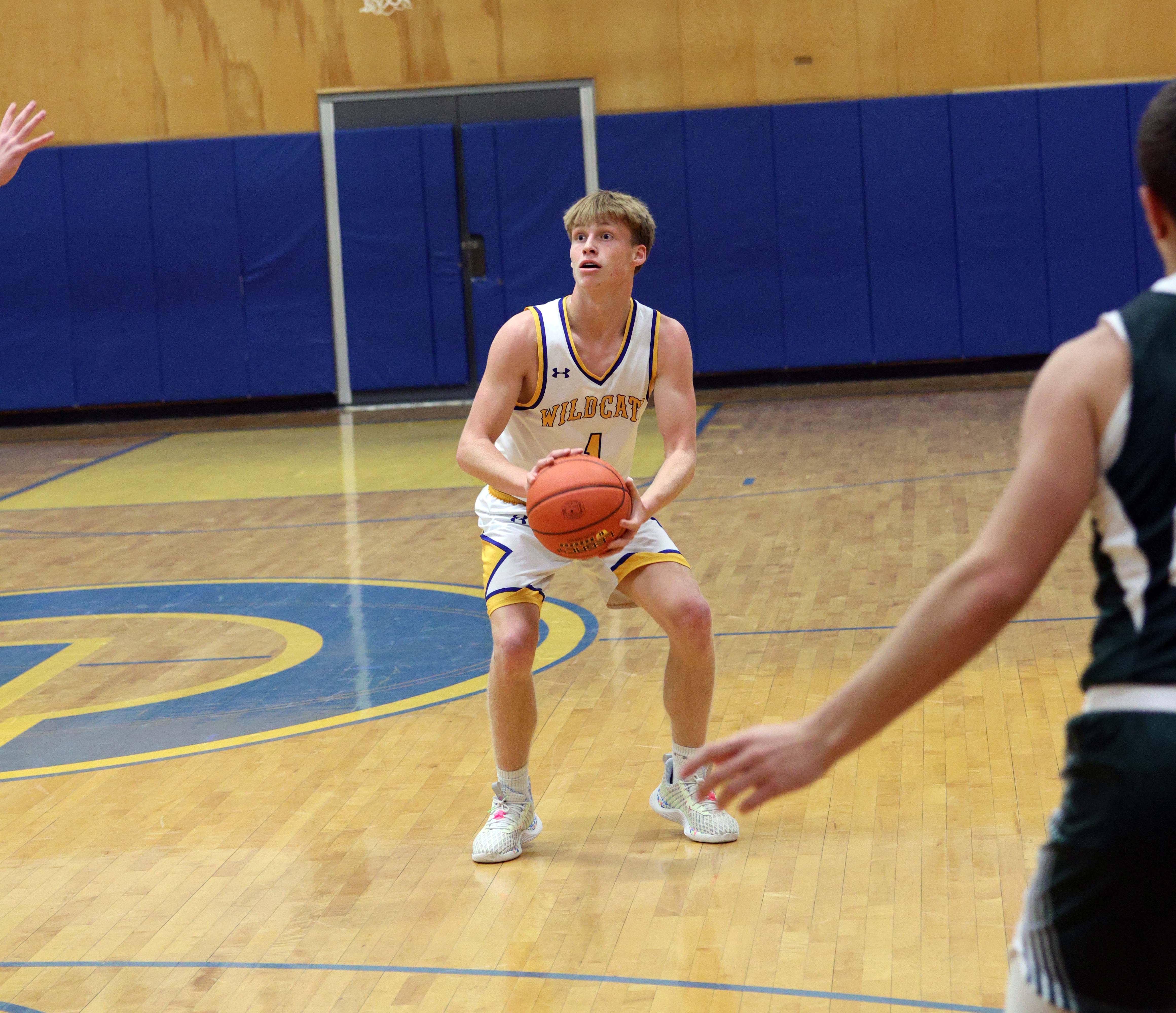 boy basketballer about ready to shoot a three point