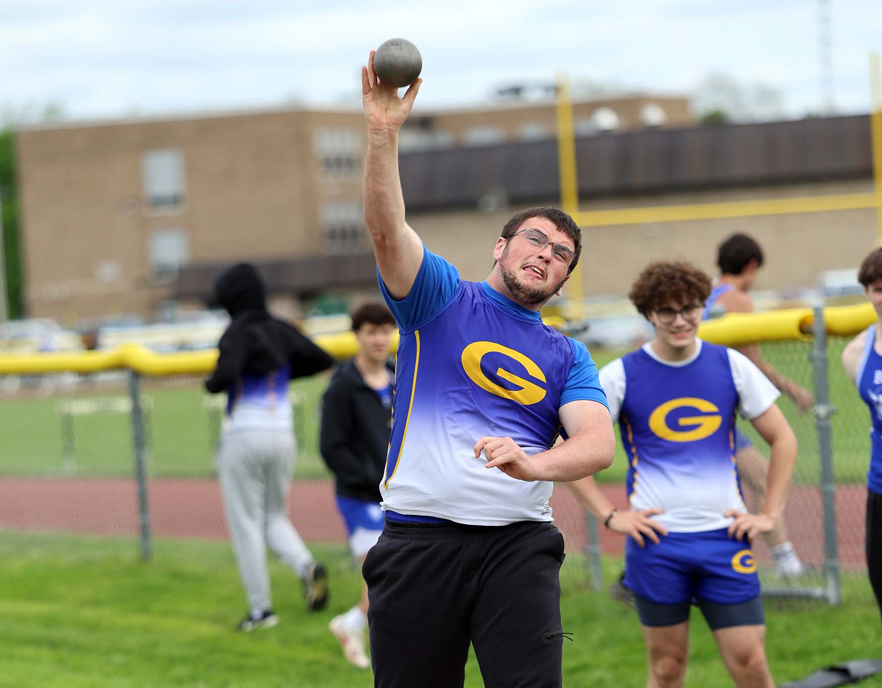 outdoor track player throwing shotput