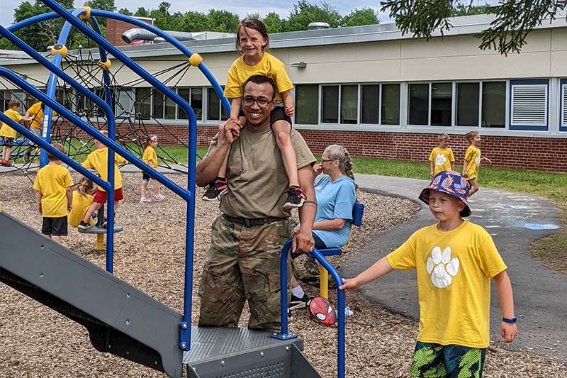 children on the playground with their family members