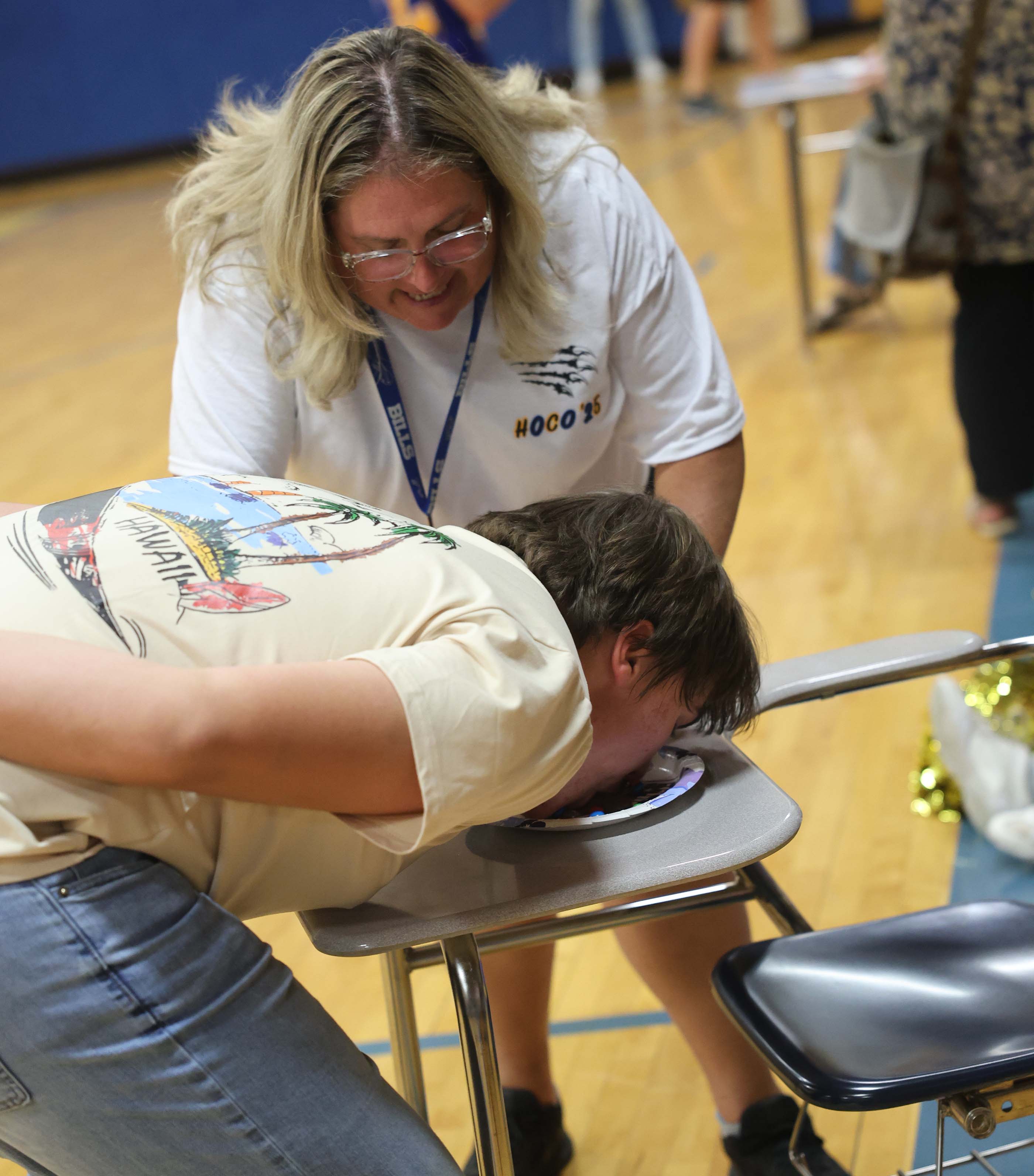 pep rally student trying to get gum out of pudding