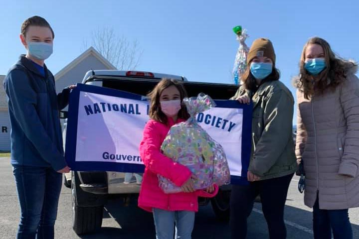 National honor society members handing out baskets during Easter